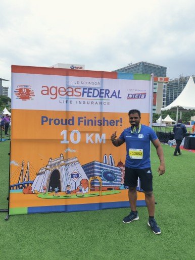 Pankaj standing in front of 10k Banner